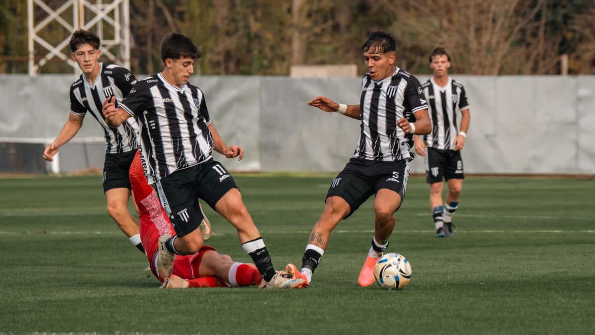 Soccer players in action on the field during a competitive match outdoors.